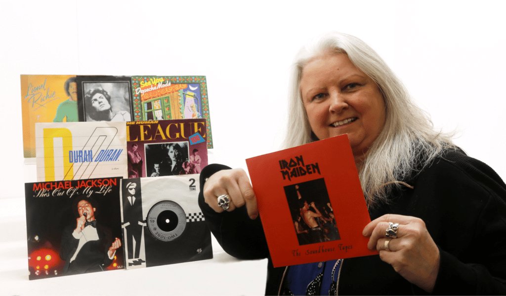 Claire Howell from Hansons Auctioneers holding Iron Maiden EP